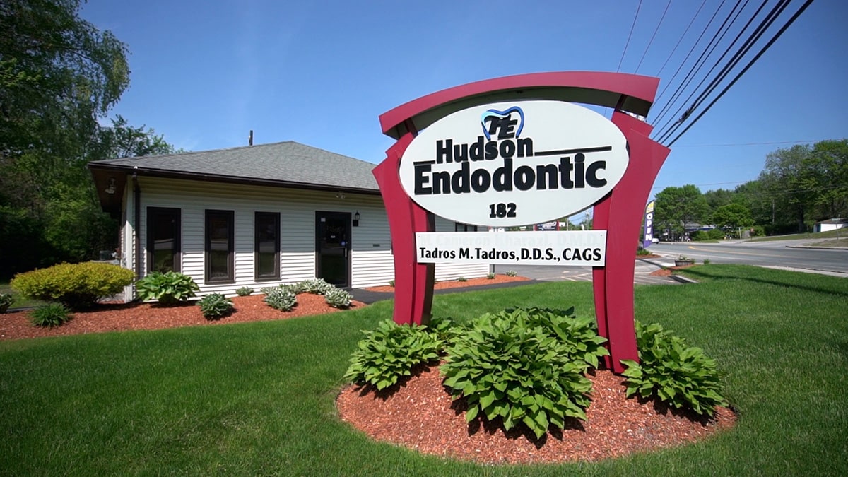 Team members standing in front of the Hudson Endodontic Sign